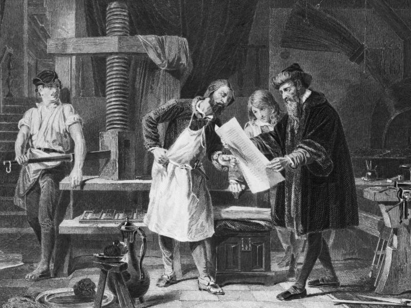 An illustration depicting Johannes Gutenberg taking the first proof off his printing press. An illustration depicting Johannes Gutenberg taking the first proof off his printing press.