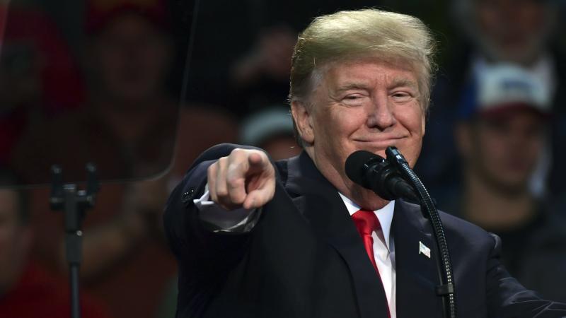President Trump points out a supporter of Roy Moore, the embattled Alabama Republican Senate candidate, as he speaks at a campaign-style rally in Pensacola, Fla., Friday. President Trump points out a supporter of Roy Moore, the embattled Alabama Republican Senate candidate, as he speaks at a campaign-style rally in Pensacola, Fla., Friday.