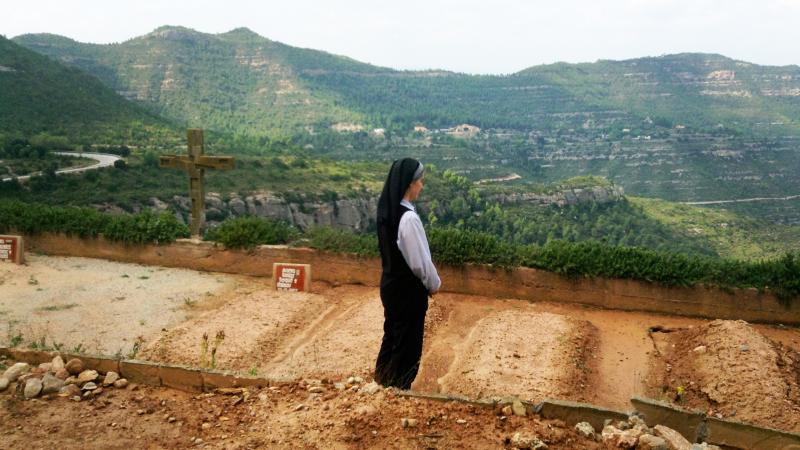 Sister Teresa Forcades prays over the graves of fellow nuns in a cemetery at her Sant Benet Monastery in Montserrat, Spain. Sister Teresa Forcades prays over the graves of fellow nuns in a cemetery at her Sant Benet Monastery in Montserrat, Spain.