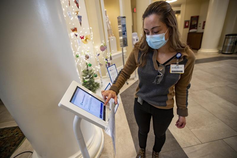 Interpreter Ana Maria Rios-Velez demonstrates the screening app at the front entrance of Brigham and Womens Hospital in Boston. It has a multilingual function to better communicate with non-English speaking patients and staff. Interpreter Ana Maria Rios-Velez demonstrates the screening app at the front entrance of Brigham and Womens Hospital in Boston. It has a multilingual function to better communicate with non-English speaking patients and staff.