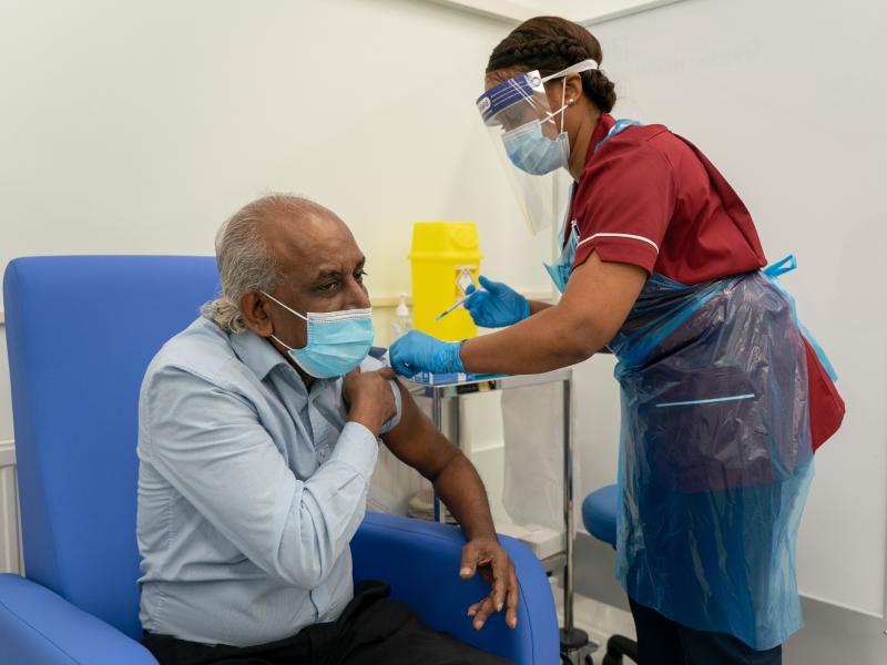 A nurse prepares to administer a COVID-19 vaccine at Croydon University Hospital in London. A nurse prepares to administer a COVID-19 vaccine at Croydon University Hospital in London.