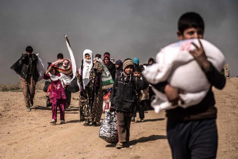 Civilians wave white flags as they flee a west Mosul suburb during heavy fighting between government forces and ISIS militants in February. Many had been warned by ISIS that they would be killed if they tried to escape. Civilians wave white flags as they flee a west Mosul suburb during heavy fighting between government forces and ISIS militants in February. Many had been warned by ISIS that they would be killed if they tried to escape.