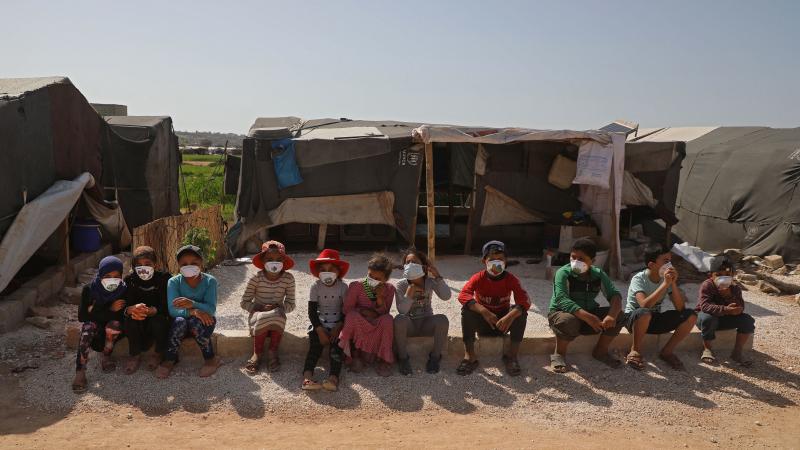 Children displaced by the war in Syria's Idlib province sit, wearing face masks during a COVID-19 awareness campaign this week in Dana. The World Food Programme warned that people living in displaced-person camps could be "particularly vulnerable" to the Children displaced by the war in Syria's Idlib province sit, wearing face masks during a COVID-19 awareness campaign this week in Dana. The World Food Programme warned that people living in displaced-person camps could be "particularly vulnerable" to the