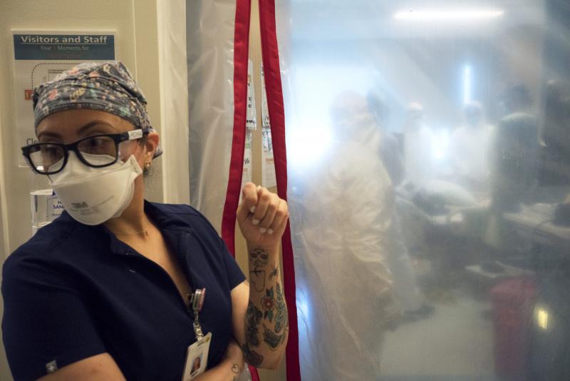 Maria Arechiga, an ICU charge nurse, monitors the progress of two COVID-19 patients in the intensive care unit of Martin Luther King Jr. Community Hospital in Los Angeles. Maria Arechiga, an ICU charge nurse, monitors the progress of two COVID-19 patients in the intensive care unit of Martin Luther King Jr. Community Hospital in Los Angeles.