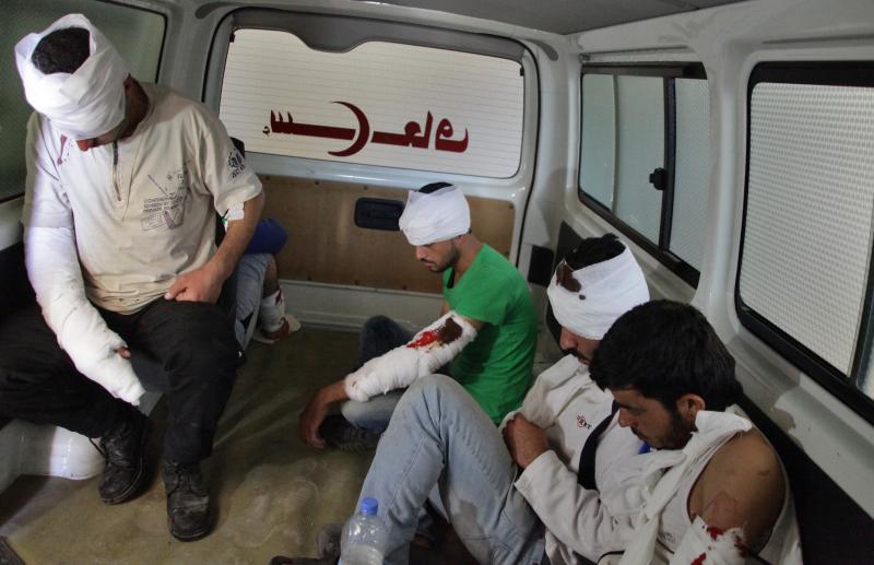 Wounded rebel fighters sit in the back of an ambulance in Aleppo on Thursday. The Syrian government and its Russian allies declared a pause in the fighting and urged rebels to leave the eastern part of the city, but clashes broke out Thursday. Wounded rebel fighters sit in the back of an ambulance in Aleppo on Thursday. The Syrian government and its Russian allies declared a pause in the fighting and urged rebels to leave the eastern part of the city, but clashes broke out Thursday.