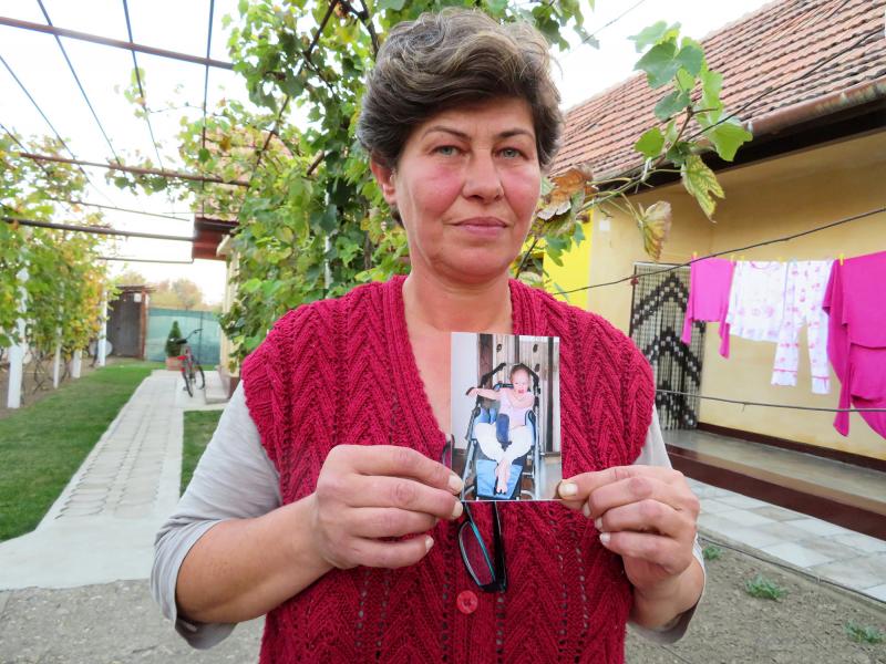 Liliana Czegledi holds a photo of her daughter, Ioana, at her home in the village of Sînandrei in western Romania. Ioana was just shy of her 10th birthday when she died of complications from measles. She could not be vaccinated because she had a compromi Liliana Czegledi holds a photo of her daughter, Ioana, at her home in the village of Sînandrei in western Romania. Ioana was just shy of her 10th birthday when she died of complications from measles. She could not be vaccinated because she had a compromi