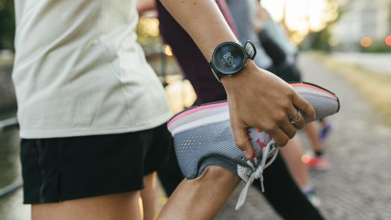 A close up of a woman stretching her legs before going on a run through the city. A close up of a woman stretching her legs before going on a run through the city.
