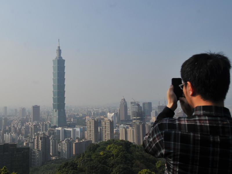 A tourist takes photos of Tower 101 in Taipei in 2013. Policy experts say the Taiwan Travel Act is a provocation for China because more visits to Taiwan by high-ranking U.S. officials could help boost the island's international profile. A tourist takes photos of Tower 101 in Taipei in 2013. Policy experts say the Taiwan Travel Act is a provocation for China because more visits to Taiwan by high-ranking U.S. officials could help boost the island's international profile.