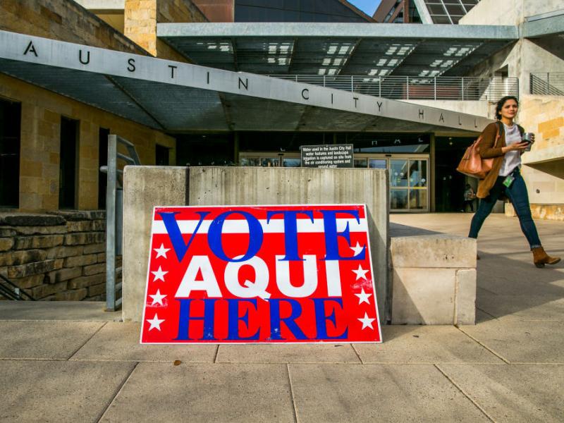 A pedestrian walks past Austin City Hall, an early voting center, on Tuesday in Austin, Texas. A pedestrian walks past Austin City Hall, an early voting center, on Tuesday in Austin, Texas.