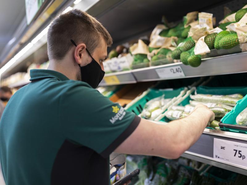 A staff member sorts through fresh produce at British supermarket chain Morrisons last month in Leeds, United Kingdom. A staff member sorts through fresh produce at British supermarket chain Morrisons last month in Leeds, United Kingdom.