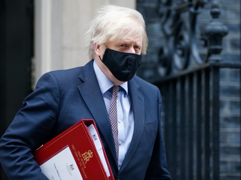 A mask-clad U.K. Prime Minister Boris Johnson departs from No. 10 Downing St. in London in March. A mask-clad U.K. Prime Minister Boris Johnson departs from No. 10 Downing St. in London in March.