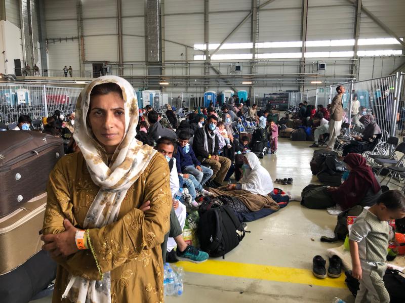 Afghan evacuees wait for the next flight to the U.S. in a fenced-in enclosure in a hangar at Ramstein Air Base in Germany. More than 25,000 Afghans have traveled through Ramstein to get to the United States. Afghan evacuees wait for the next flight to the U.S. in a fenced-in enclosure in a hangar at Ramstein Air Base in Germany. More than 25,000 Afghans have traveled through Ramstein to get to the United States.