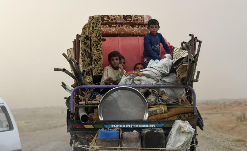 Displaced Syrians head to refugee camps on the outskirts of Raqqa on Sunday. Syrian fighters, backed by the U.S., have been driving out the Islamic State. However, many civilians are fleeing the fighting, and there's still no sign of a political settlemen Displaced Syrians head to refugee camps on the outskirts of Raqqa on Sunday. Syrian fighters, backed by the U.S., have been driving out the Islamic State. However, many civilians are fleeing the fighting, and there's still no sign of a political settlemen