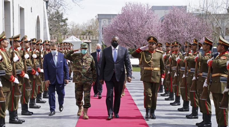 U.S. Defense Secretary Lloyd Austin (center) reviews an honor guard at Afghanistan's presidential palace in Kabul on March 21. President Biden says all U.S. troops will leave Afghanistan by September, though the Americans will still assist from "over the U.S. Defense Secretary Lloyd Austin (center) reviews an honor guard at Afghanistan's presidential palace in Kabul on March 21. President Biden says all U.S. troops will leave Afghanistan by September, though the Americans will still assist from "over the