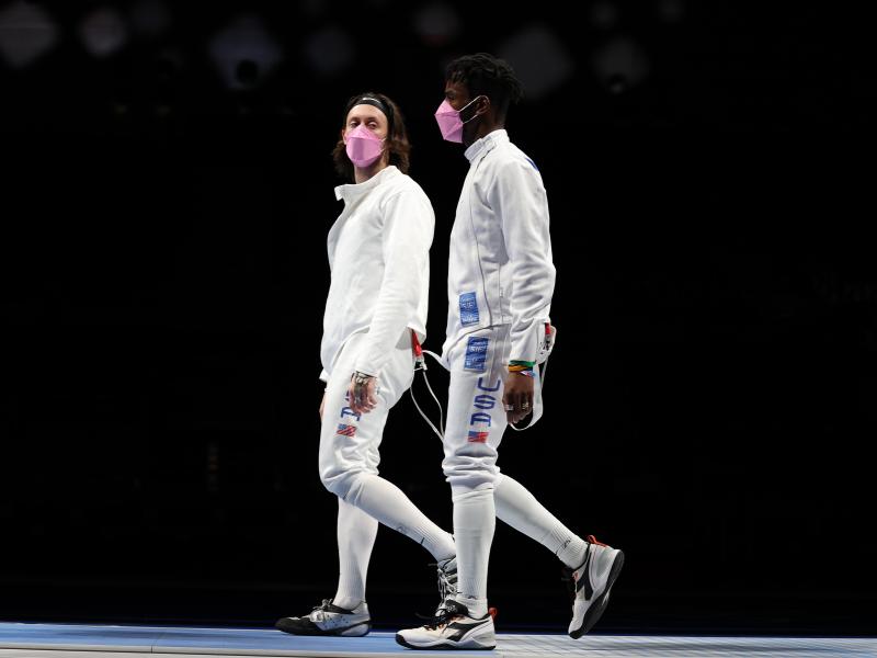 American's Jacob Hoyle and Curtis McDowald wear pink face masks after losing to Japan in Men's Épée. American's Jacob Hoyle and Curtis McDowald wear pink face masks after losing to Japan in Men's Épée.