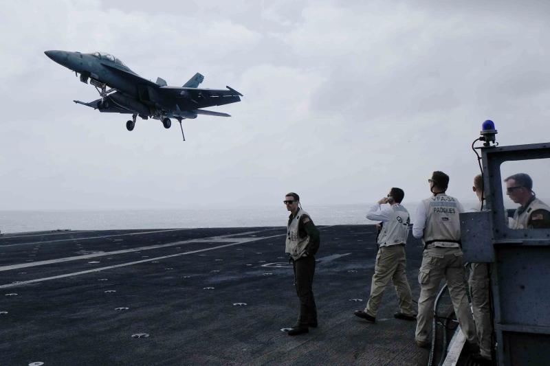A Navy fighter jet comes in for a landing on the aircraft carrier USS Carl Vinson in the South China Sea. A Navy fighter jet comes in for a landing on the aircraft carrier USS Carl Vinson in the South China Sea.