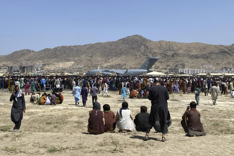 Hundreds of people gather near a U.S. Air Force C-17 transport plane at the perimeter of the international airport in Kabul, Afghanistan, on Aug. 16, 2021. SIGAR, released its interim report Wednesday detailing why Afghanistan's government and military co Hundreds of people gather near a U.S. Air Force C-17 transport plane at the perimeter of the international airport in Kabul, Afghanistan, on Aug. 16, 2021. SIGAR, released its interim report Wednesday detailing why Afghanistan's government and military co