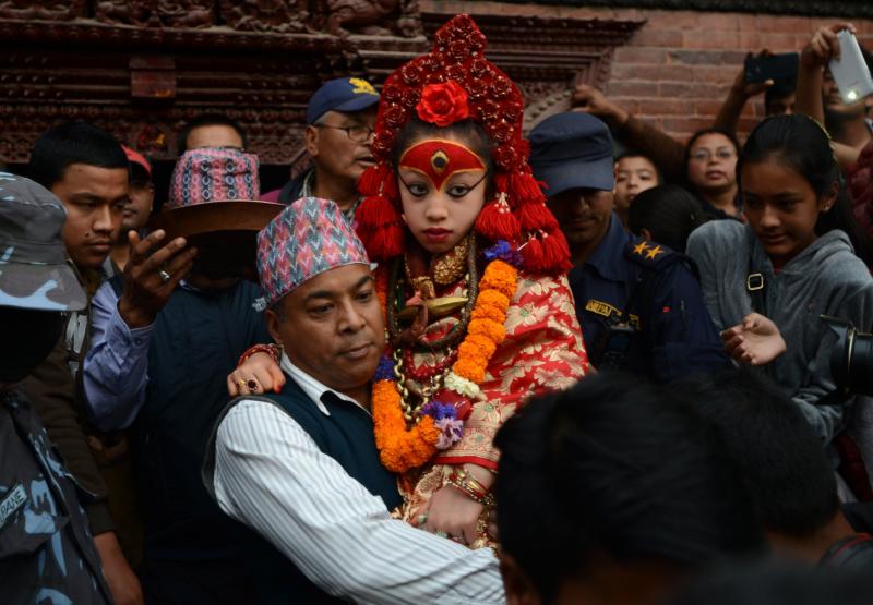 Nepal's Living Goddess, the Kumari Devi, 9, observes a chariot festival in Kathmandu on March 29. The goddess is worshipped by both Hindus and Buddhists. She's selected as a young child and lives an isolated and secretive existence and is rarely seen in p Nepal's Living Goddess, the Kumari Devi, 9, observes a chariot festival in Kathmandu on March 29. The goddess is worshipped by both Hindus and Buddhists. She's selected as a young child and lives an isolated and secretive existence and is rarely seen in p