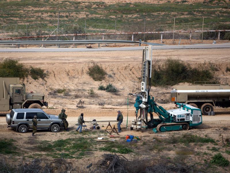 Israeli soldiers watch as a machine drills holes on the Israeli side of the border with the Gaza Strip, as they search for tunnels reportedly used by Hamas for fighting Israel, on Feb. 10. Israeli soldiers watch as a machine drills holes on the Israeli side of the border with the Gaza Strip, as they search for tunnels reportedly used by Hamas for fighting Israel, on Feb. 10.