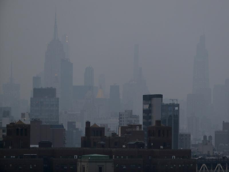 A thick haze hangs over Manhattan on Tuesday. Wildfires in the West, including the Bootleg Fire in Oregon, are creating hazy skies and poor air quality as far away as the East Coast. A thick haze hangs over Manhattan on Tuesday. Wildfires in the West, including the Bootleg Fire in Oregon, are creating hazy skies and poor air quality as far away as the East Coast.