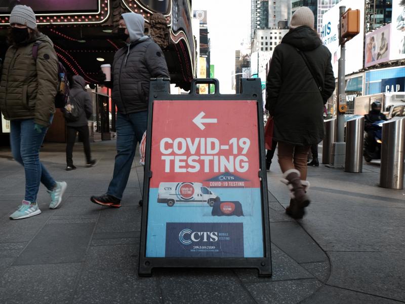 People pass a COVID-19 testing site on a Manhattan street on Jan. 21. The White House says it is running out of money to pay for coronavirus tests for people who don't have insurance. People pass a COVID-19 testing site on a Manhattan street on Jan. 21. The White House says it is running out of money to pay for coronavirus tests for people who don't have insurance.