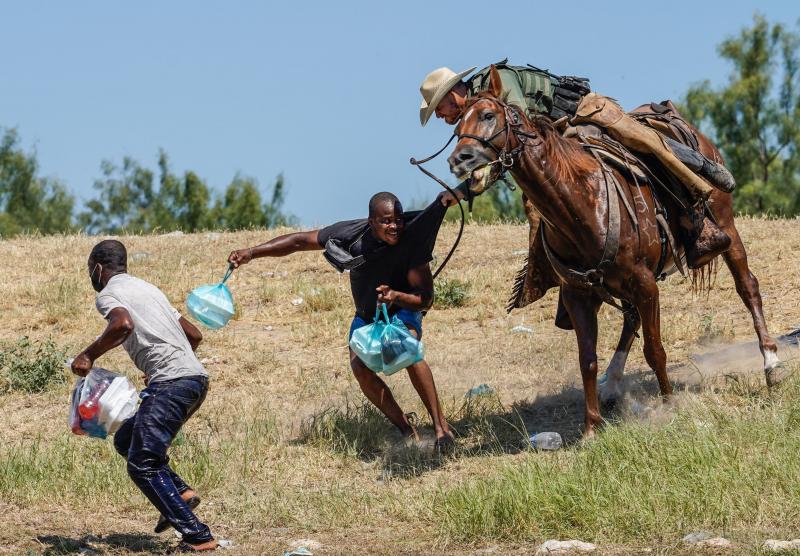 A United States Border Patrol agent on horseback tries to stop a Haitian migrant from entering an encampment on the banks of the Rio Grande near the Acuna Del Rio International Bridge in Del Rio, Texas on Sept. 19, 2021. A United States Border Patrol agent on horseback tries to stop a Haitian migrant from entering an encampment on the banks of the Rio Grande near the Acuna Del Rio International Bridge in Del Rio, Texas on Sept. 19, 2021.