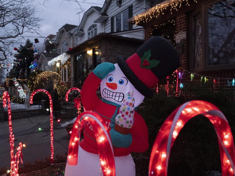 An inflatable snowman and candy canes are part of the decorations that adorn houses in Brooklyn's Dyker Heights neighborhood on Dec. 22, 2020 in New York. A shopping surge by households this year has snarled up global supply chains, and now the race is on An inflatable snowman and candy canes are part of the decorations that adorn houses in Brooklyn's Dyker Heights neighborhood on Dec. 22, 2020 in New York. A shopping surge by households this year has snarled up global supply chains, and now the race is on