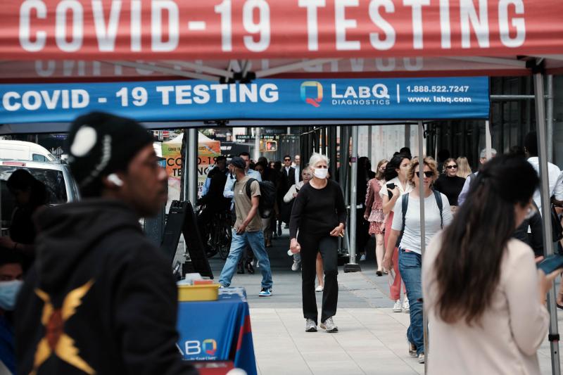People walk past a COVID testing site on May 17 in New York City. New York's health commissioner, Dr. Ashwin Vasan, has moved from a "medium" COVID-19 alert level to a "high" alert level in all the five boroughs following a surge in cases. People walk past a COVID testing site on May 17 in New York City. New York's health commissioner, Dr. Ashwin Vasan, has moved from a "medium" COVID-19 alert level to a "high" alert level in all the five boroughs following a surge in cases.