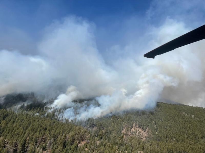 In this photo provided by the New Mexico National Guard, a New Mexico National Guard Aviation UH-60 Black Hawk flies as part of firefighting efforts, dropping thousands of gallons of water with Bambi buckets from the air on the Calf Canyon/Hermits Peak fi In this photo provided by the New Mexico National Guard, a New Mexico National Guard Aviation UH-60 Black Hawk flies as part of firefighting efforts, dropping thousands of gallons of water with Bambi buckets from the air on the Calf Canyon/Hermits Peak fi