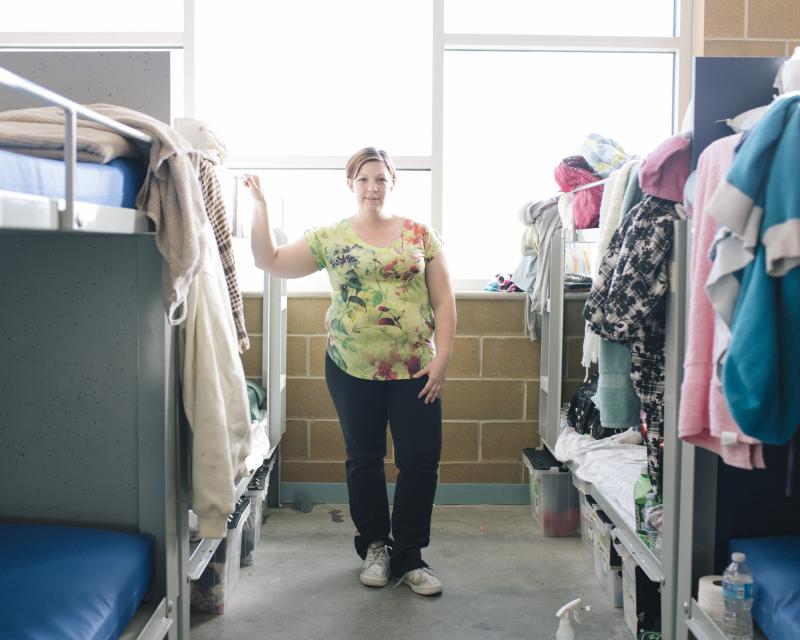 Jennifer Carter, 30, stands in a dormitory area that she shares with her two young children at The Road Home Community Winter Shelter facility in Midvale, Utah. Jennifer Carter, 30, stands in a dormitory area that she shares with her two young children at The Road Home Community Winter Shelter facility in Midvale, Utah.