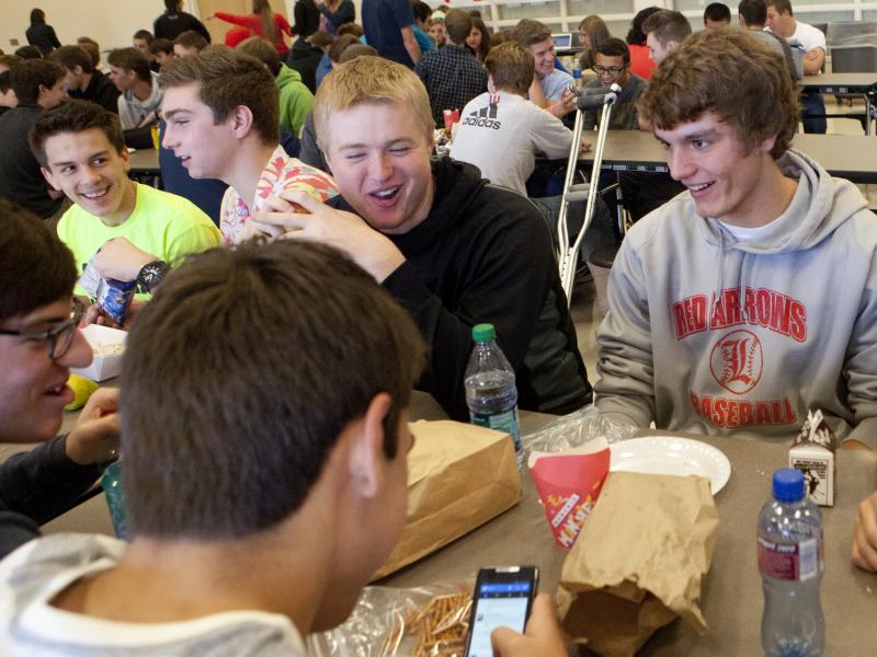 Students at Lowell High School in Michigan sit down for lunch. Shorter lunch breaks mean that many kids don't get enough time to eat and socialize. Students at Lowell High School in Michigan sit down for lunch. Shorter lunch breaks mean that many kids don't get enough time to eat and socialize.