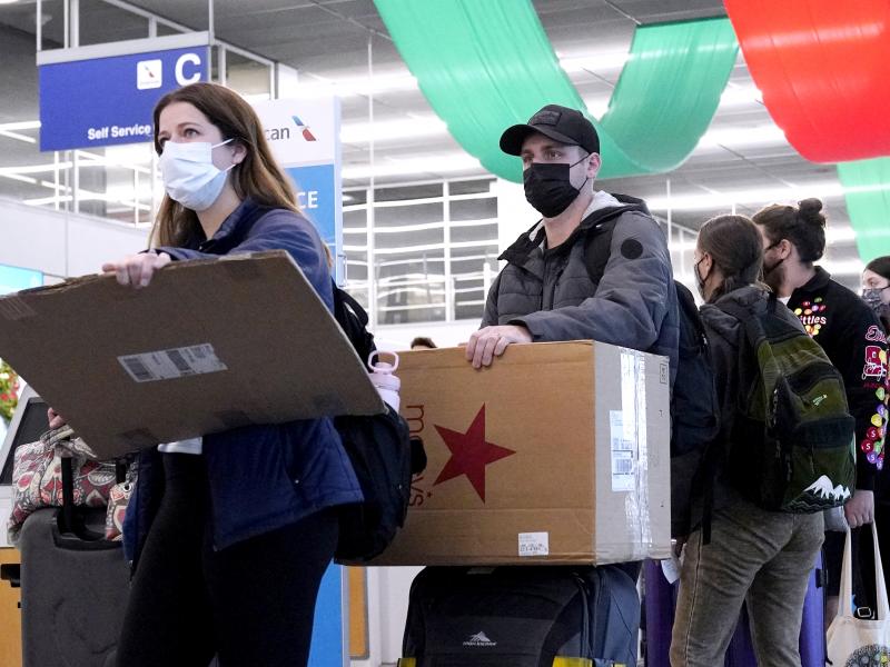 Travelers line up wearing protective masks indoors at O'Hare International Airport in Chicago in December 2021. U.S. District Judge Kathryn Kimball Mizelle voided the national travel mask mandate on Monday. Travelers line up wearing protective masks indoors at O'Hare International Airport in Chicago in December 2021. U.S. District Judge Kathryn Kimball Mizelle voided the national travel mask mandate on Monday.