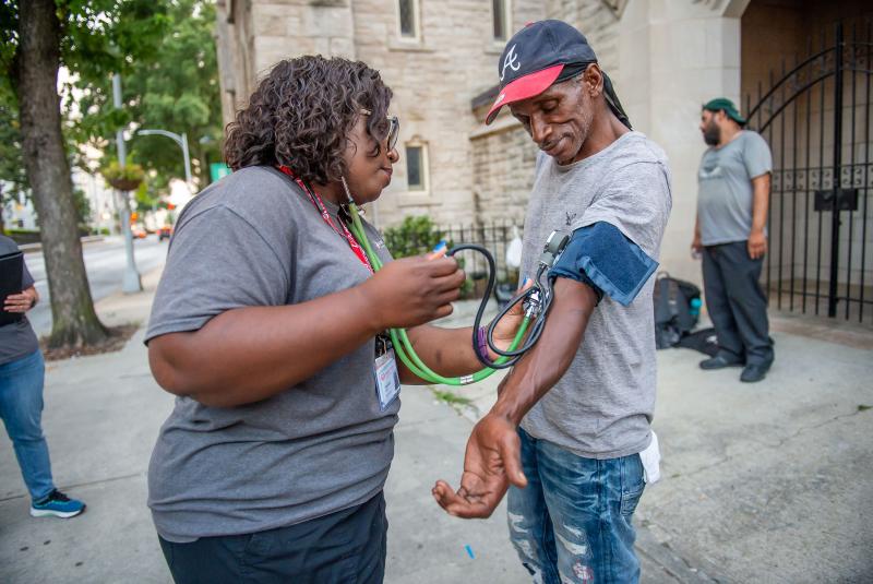 Licensed practical nurse Stephanie Dotson measures Kent Beasley's blood pressure in downtown Atlanta in September. Dotson is a member of the Mercy Care team that works to bring medical care to Atlanta residents who are homeless. Licensed practical nurse Stephanie Dotson measures Kent Beasley's blood pressure in downtown Atlanta in September. Dotson is a member of the Mercy Care team that works to bring medical care to Atlanta residents who are homeless.