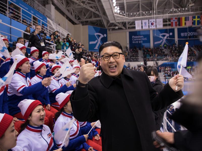 A man impersonating Kim Jong Un throws out a thumbs up in front of the North Korean cheerleaders attending an Olympic women's ice hockey game Wednesday. A man impersonating Kim Jong Un throws out a thumbs up in front of the North Korean cheerleaders attending an Olympic women's ice hockey game Wednesday.