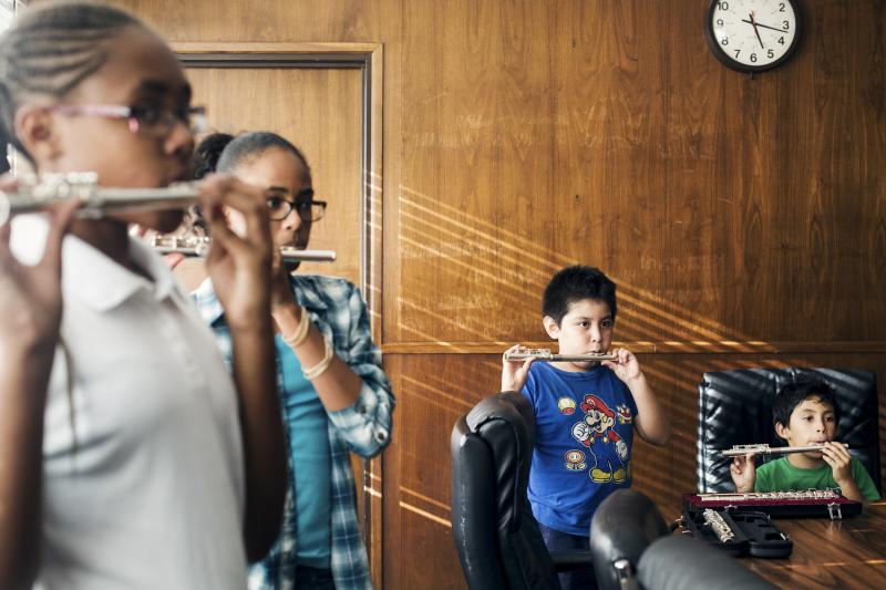 A class for beginning flutists, crammed into an office building boardroom, labor over "Hot Cross Buns." It's part of Harmony Project, a nonprofit program offering music lessons in a wide range of instruments — flute, trombone, trumpet, oboe, violin, cel A class for beginning flutists, crammed into an office building boardroom, labor over "Hot Cross Buns." It's part of Harmony Project, a nonprofit program offering music lessons in a wide range of instruments — flute, trombone, trumpet, oboe, violin, cel