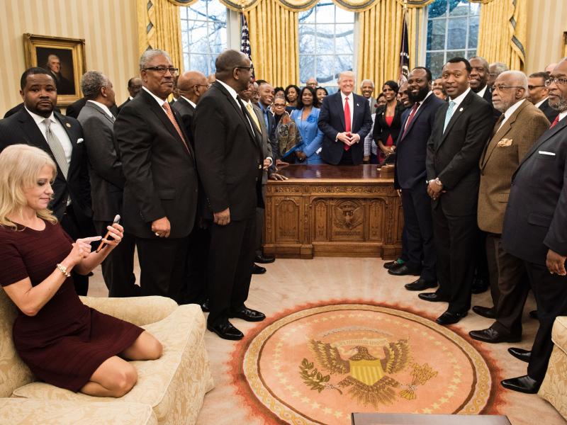 Counselor to the President Kellyanne Conway, left, checks her phone Tuesday after taking a photo as President Trump and leaders of historically black colleges and universities pose for a group photo in the Oval Office. Counselor to the President Kellyanne Conway, left, checks her phone Tuesday after taking a photo as President Trump and leaders of historically black colleges and universities pose for a group photo in the Oval Office.