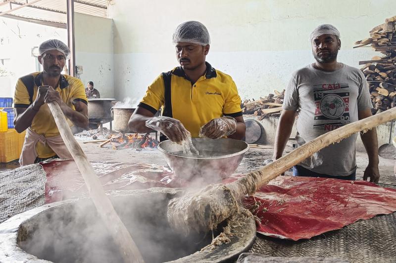 Workers pound the steaming mixture of meat, lentils, wheat and spices with long wooden paddles to give the haleem its signature smooth texture. Workers pound the steaming mixture of meat, lentils, wheat and spices with long wooden paddles to give the haleem its signature smooth texture.