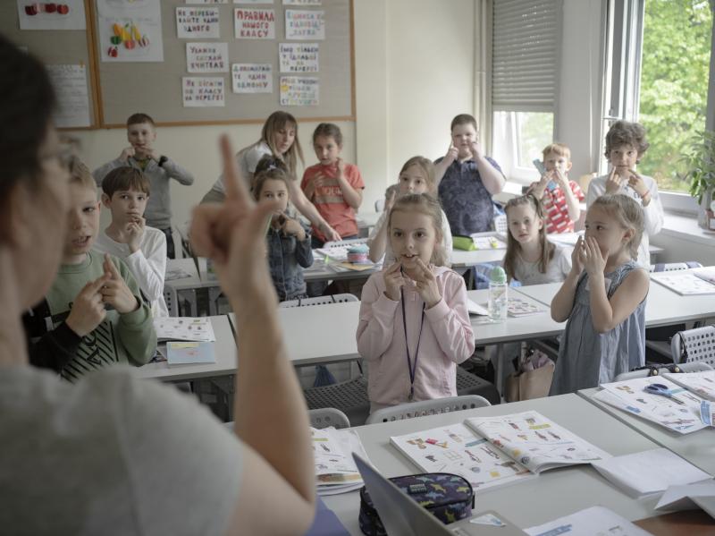 Students interact with a teacher during a lesson at Poland's Warsaw Ukrainian School, on Wednesday, May 11, 2022. Students interact with a teacher during a lesson at Poland's Warsaw Ukrainian School, on Wednesday, May 11, 2022.