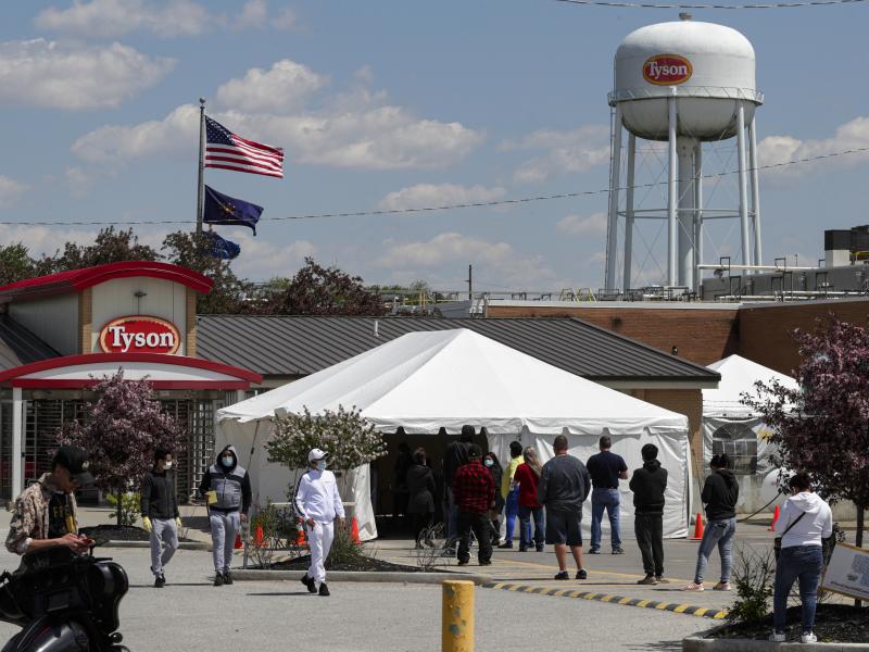 Workers line up to enter a Tyson Foods pork processing plant last month in Logansport, Ind. Some of the worst workplace coronavirus outbreaks have been in the meatpacking industry. Major meatpackers JBS USA, Smithfield Foods and Tyson have said worker saf Workers line up to enter a Tyson Foods pork processing plant last month in Logansport, Ind. Some of the worst workplace coronavirus outbreaks have been in the meatpacking industry. Major meatpackers JBS USA, Smithfield Foods and Tyson have said worker saf