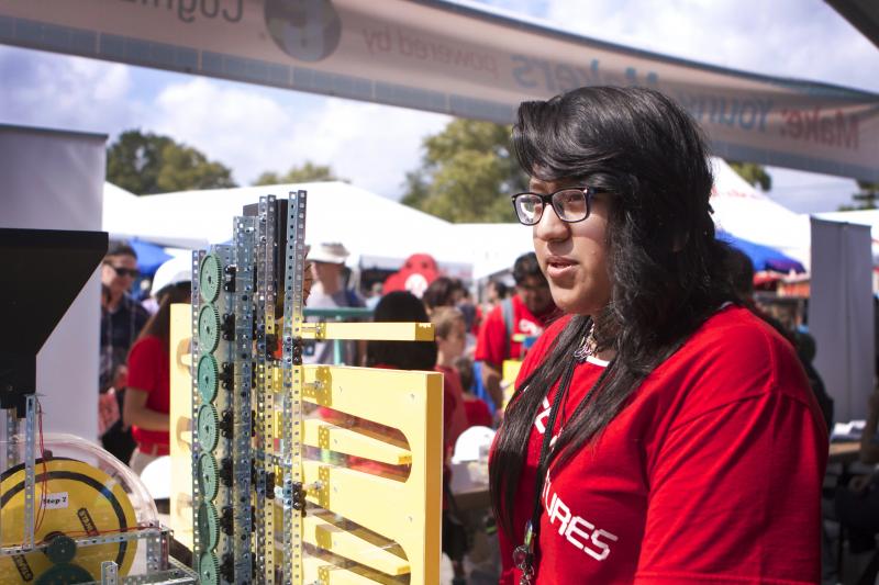 Jessica Yanez, 17, shows off a Rube Goldberg machine built by middle school participants in an after-school maker program called CPEP. Jessica Yanez, 17, shows off a Rube Goldberg machine built by middle school participants in an after-school maker program called CPEP.