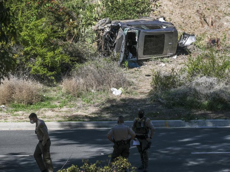 A vehicle rests on its side after a rollover accident involving golfer Tiger Woods along a road in the Rancho Palos Verdes section of Los Angeles County on Tuesday. Woods suffered leg injuries in the one-car accident and was undergoing surgery, authoritie A vehicle rests on its side after a rollover accident involving golfer Tiger Woods along a road in the Rancho Palos Verdes section of Los Angeles County on Tuesday. Woods suffered leg injuries in the one-car accident and was undergoing surgery, authoritie