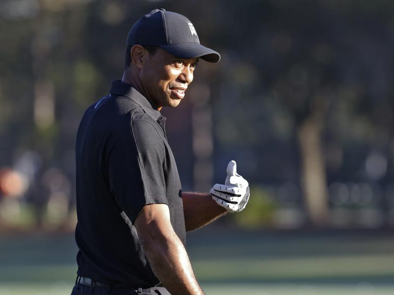 Tiger Woods smiles and gestures as he prepares to tee off during the first round of the PNC Championship golf tournament Friday in Orlando, Fla. Woods is back playing after getting injured in a car accident. He is paired with his son Charlie during the to Tiger Woods smiles and gestures as he prepares to tee off during the first round of the PNC Championship golf tournament Friday in Orlando, Fla. Woods is back playing after getting injured in a car accident. He is paired with his son Charlie during the to