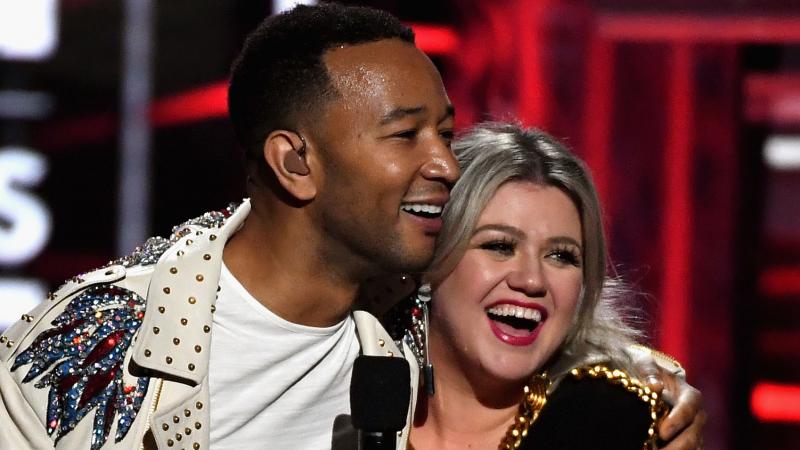 John Legend and Kelly Clarkson, onstage during the 2018 Billboard Music Awards at MGM Grand Garden Arena on May 20, 2018 in Las Vegas, Nevada. John Legend and Kelly Clarkson, onstage during the 2018 Billboard Music Awards at MGM Grand Garden Arena on May 20, 2018 in Las Vegas, Nevada.