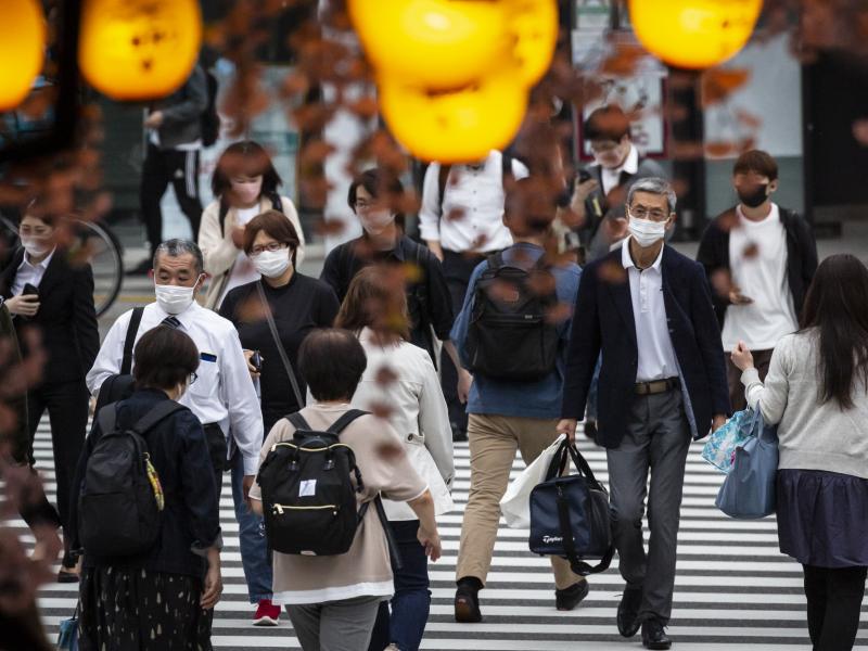 People in Tokyo wear masks on May 7. Daily coronavirus infections in Japan's capital have topped 4,000 — nearly four times as many as a week ago. People in Tokyo wear masks on May 7. Daily coronavirus infections in Japan's capital have topped 4,000 — nearly four times as many as a week ago.