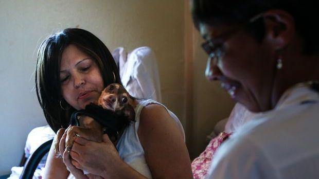 Sandra Lopez (left) and her dog, Coco, greet hospice nurse Heather Meyerend last fall. In the weeks before Lopez died, Meyerend stopped by weekly to check her physical health, pain levels and medications. Sandra Lopez (left) and her dog, Coco, greet hospice nurse Heather Meyerend last fall. In the weeks before Lopez died, Meyerend stopped by weekly to check her physical health, pain levels and medications.