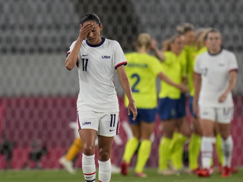 U.S. player Christen Press reacts as Sweden's players celebrate their third goal during a women's soccer match at the Olympics on Wednesday in Tokyo. U.S. player Christen Press reacts as Sweden's players celebrate their third goal during a women's soccer match at the Olympics on Wednesday in Tokyo.