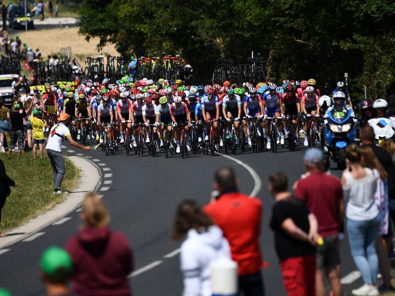 Spectators watch cyclists compete in the fourth stage of the Tour de France in eastern France last July. Organizers say the 2020 race will be postponed, though new dates have not been set. Spectators watch cyclists compete in the fourth stage of the Tour de France in eastern France last July. Organizers say the 2020 race will be postponed, though new dates have not been set.