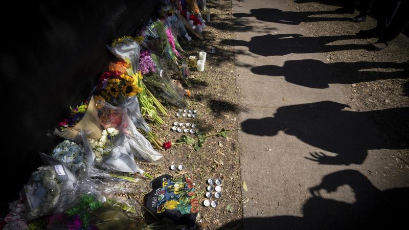 Visitors cast shadows at a memorial to the victims of the Astroworld concert in Houston on Sunday, Nov. 7, 2021. Visitors cast shadows at a memorial to the victims of the Astroworld concert in Houston on Sunday, Nov. 7, 2021.