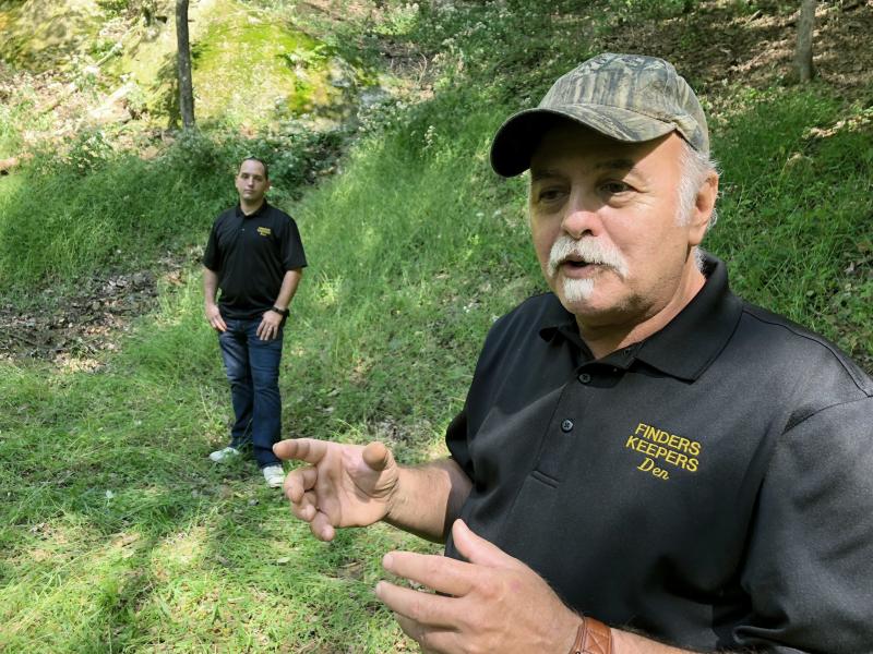 Dennis Parada, right, and his son Kem Parada stand at the site of the FBI's dig for Civil War-era gold in September 2018 in Dents Run, Penn. A scientific report commissioned by the FBI shortly before agents went digging for buried treasure suggested that Dennis Parada, right, and his son Kem Parada stand at the site of the FBI's dig for Civil War-era gold in September 2018 in Dents Run, Penn. A scientific report commissioned by the FBI shortly before agents went digging for buried treasure suggested that