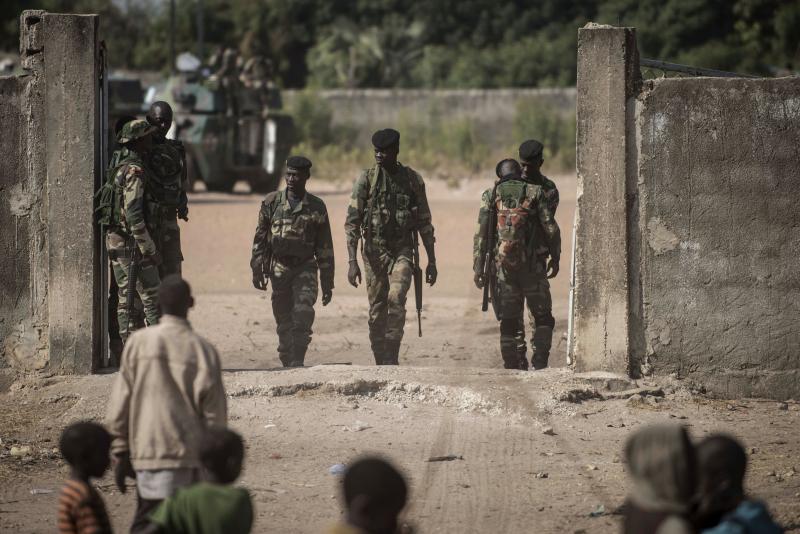 Children watch Senegalese soldiers on Friday in the town of Karang, Senegal, near the border with Gambia. Children watch Senegalese soldiers on Friday in the town of Karang, Senegal, near the border with Gambia.